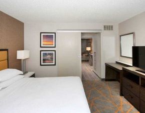 Comfortable bedroom in a king suite at the Embassy Suites by Hilton Cincinnati Blue Ash.