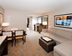 Living room with working station in a hotel suite at the Embassy Suites by Hilton Cincinnati Blue Ash.