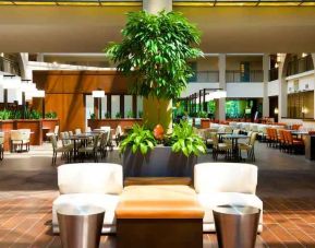Elegant lobby workspace with plants at the Embassy Suites by Hilton Cincinnati Blue Ash.