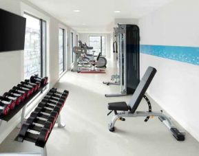 Bright fitness room with weights at the Hampton by Hilton London Docklands.