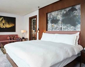Elegant king bedroom with sofa at the Hilton London Bankside.