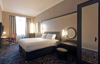 Deluxe room with king size bed at the DoubleTree by Hilton Edinburgh City Centre.
