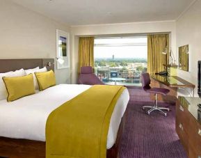 spacious king suite with work area and TV at Hilton London Metropole.