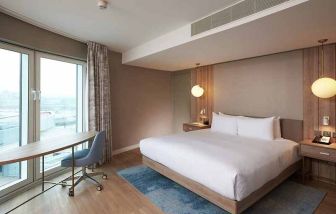 comfortable king room with work desk and lots of natural light at DoubleTree by Hilton London ExCel.