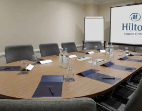 Meeting room with screen and blackboard at the Hilton London Euston.