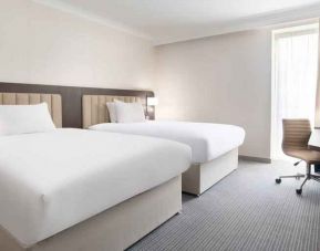 Double guest room with TV screen and desk at the Hilton London Gatwick Airport.