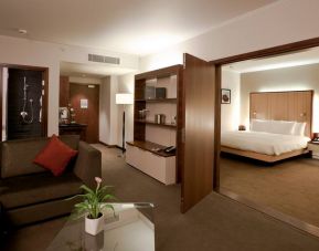 Deluxe suite with king size bed and sofa at the Hilton London Heathrow Airport Terminal 5.