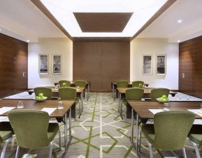 Large coworking or conference meeting room with six tables of four seats each,