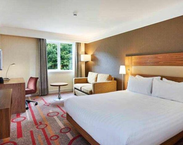 King guestroom with desk and sofa at the DoubleTree by Hilton Newbury North.