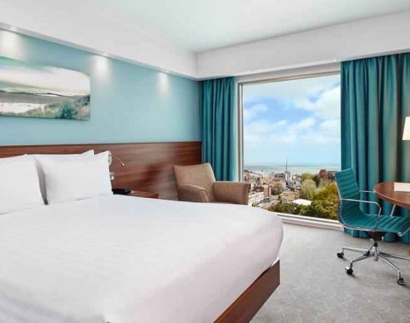 King room with sea view and desk at the Hampton by Hilton Bournemouth.