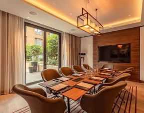 Small meeting room with TV screen at the Fellows House Cambridge, Curio Collection by Hilton.