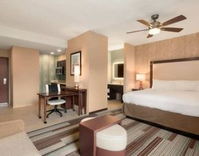 Open layout king size suite with king bed, tv, and kitchenette at the Homewood Suite by Hilton Atlanta Perimeter.