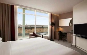 beautiful king suite with TV, work desk, and lounge at Hilton London Angel Islington.