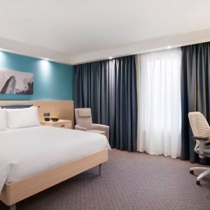 King bedroom with working station at the Hampton by Hilton Bristol Airport.