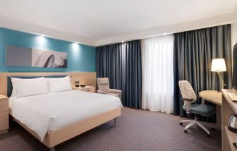 King bedroom with working station at the Hampton by Hilton Bristol Airport.