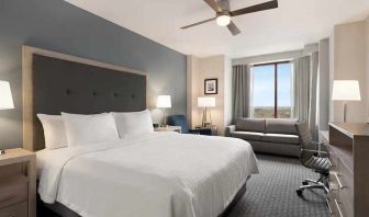 Spacious king suite with work area and TV at Homewood Suites by Hilton University City Philadelphia, PA.