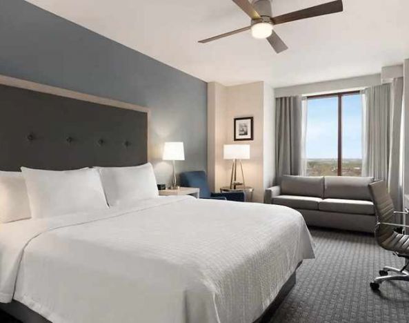 Spacious king suite with work area and TV at Homewood Suites by Hilton University City Philadelphia, PA.