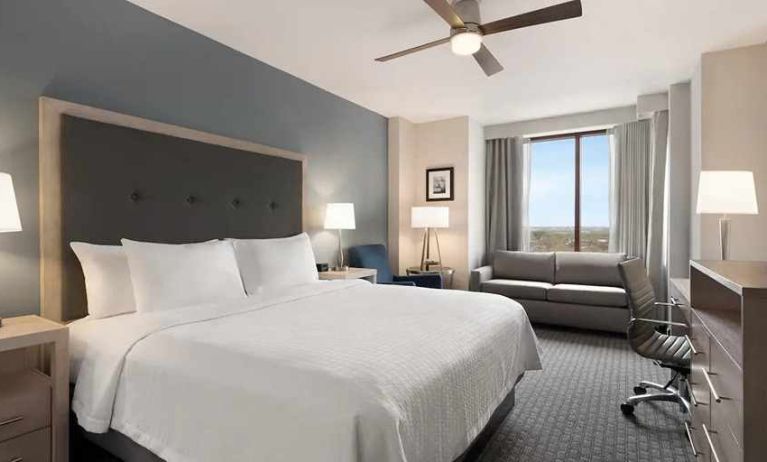 Spacious king suite with work area and TV at Homewood Suites by Hilton University City Philadelphia, PA.