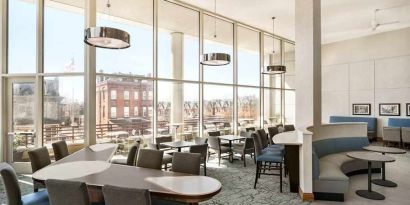 Comfortable lounge and coworking space with lots of natural light at Homewood Suites by Hilton University City Philadelphia, PA.