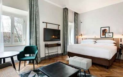 Spacious king bedroom with desk and TV screen at the DoubleTree by Hilton Rome Monti.