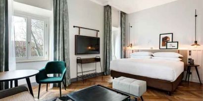 Spacious king bedroom with desk and TV screen at the DoubleTree by Hilton Rome Monti.