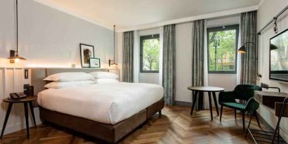Bright king guestroom with working station at the DoubleTree by Hilton Rome Monti.