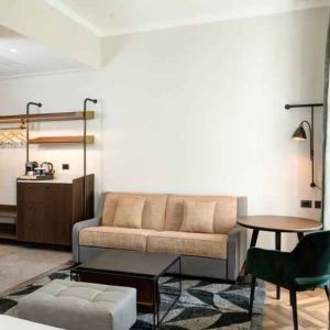 Living room with desk and sofa at the DoubleTree by Hilton Rome Monti.