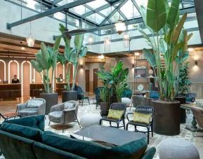 Beautiful lobby workspace with plants at the DoubleTree by Hilton Rome Monti.