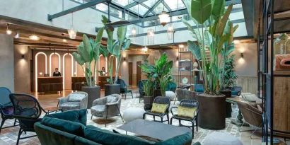 Beautiful lobby workspace with plants at the DoubleTree by Hilton Rome Monti.