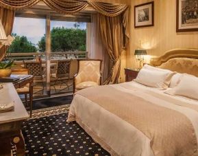 King bedroom with balcony at the Rome Cavalieri, A Waldorf Astoria Hotel.
