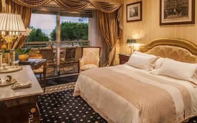 King bedroom with balcony at the Rome Cavalieri, A Waldorf Astoria Hotel.