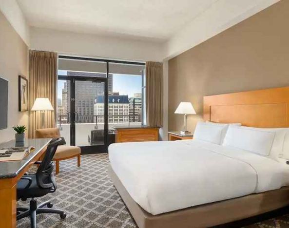 spacious king suite with work desk and city views at Hilton San Francisco Financial District.