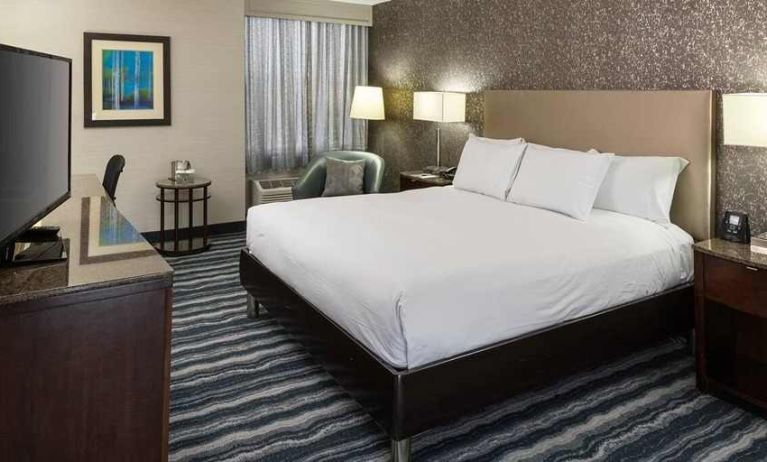 Comfortable king room with TV and work desk ideal for working remotely at DoubleTree by Hilton Hotel Wilmington.