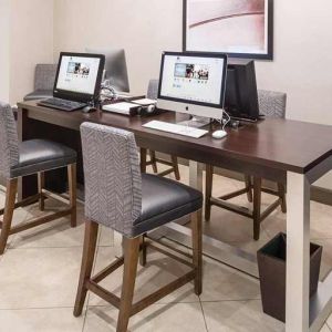Business center and coworking space equipped with work desk, PC, internet, and printers at DoubleTree by Hilton Hotel Wilmington.