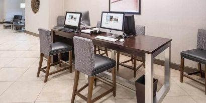 Business center and coworking space equipped with work desk, PC, internet, and printers at DoubleTree by Hilton Hotel Wilmington.