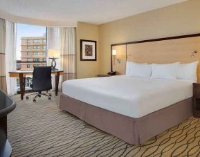 spacious king room with TV and work area ideal for working remotely at Hilton Rosemont/Chicago O'Hare.