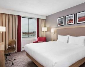 Bright king bedroom with desk and TV screen at the Hilton Garden Inn Dublin Custom House.