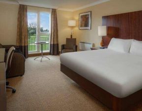 King bedroom with desk at the Hilton Belfast Templepatrick Golf & Country Club.