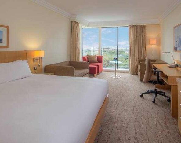 Large king suite with working station at the Hilton Dublin Airport.