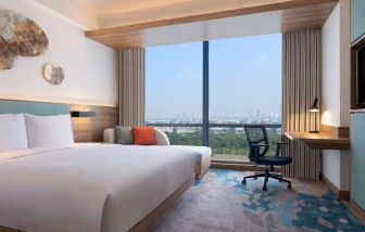 King bedroom with desk along the window at the Hilton Garden Inn Jakarta Taman Palem.