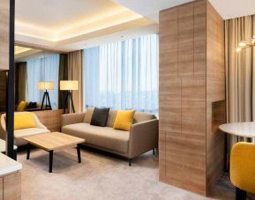Spacious living room with working station in a king suite at the Hilton Garden Inn Jakarta Taman Palem.