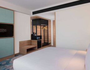 Comfortable king size bed in a king guestroom at the Hilton Garden Inn Jakarta Taman Palem.