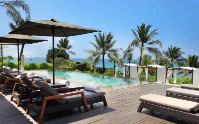 Outdoor pool with lounges at the Hilton Bali Resort.