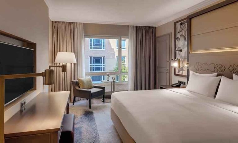 Bright king bedroom with desk at the Hilton Munich City.