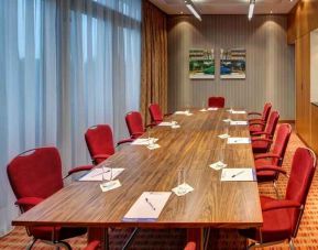Meeting room with large windows at the Hilton Garden Inn Frankfurt Airport.