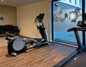 Fitness center with treadmill and machines at the Hampton by Hilton Kaiserslautern.