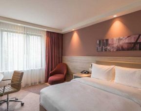 King guestroom with desk and window at the Hampton by Hilton Frankfurt City Centre East.