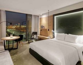 King bedroom with desk along the window at the Hilton Munich Airport.