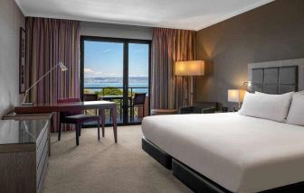 King bedroom with lake view at the Hilton Evian-les-Bains.