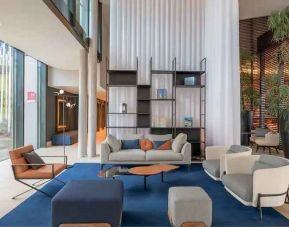 Bright lobby workspace with sofas at the Hilton Evian-les-Bains.